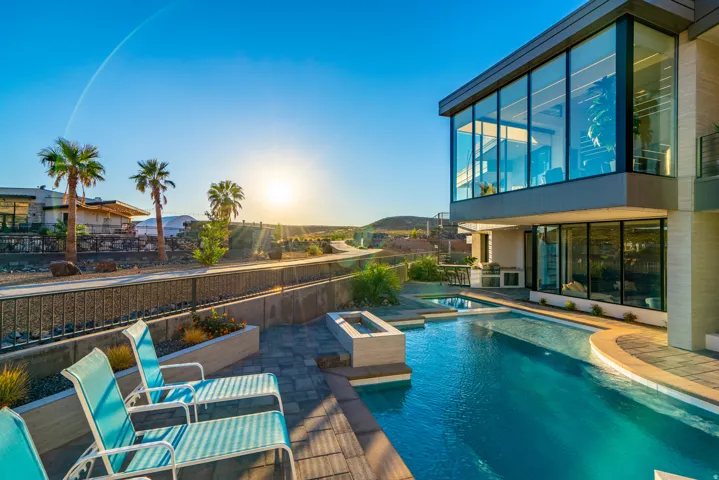 View of pool with a patio, a pool with connected hot tub, and a balcony
