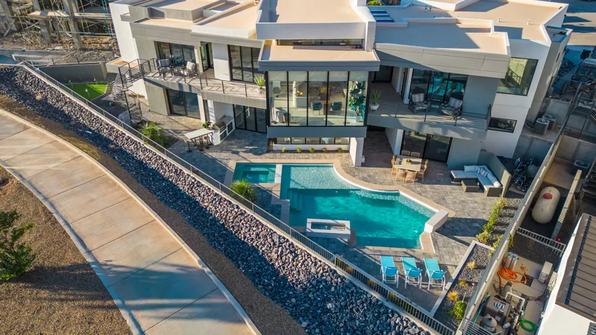 View of pool featuring outdoor lounge area, a balcony, a patio, and a fenced backyard