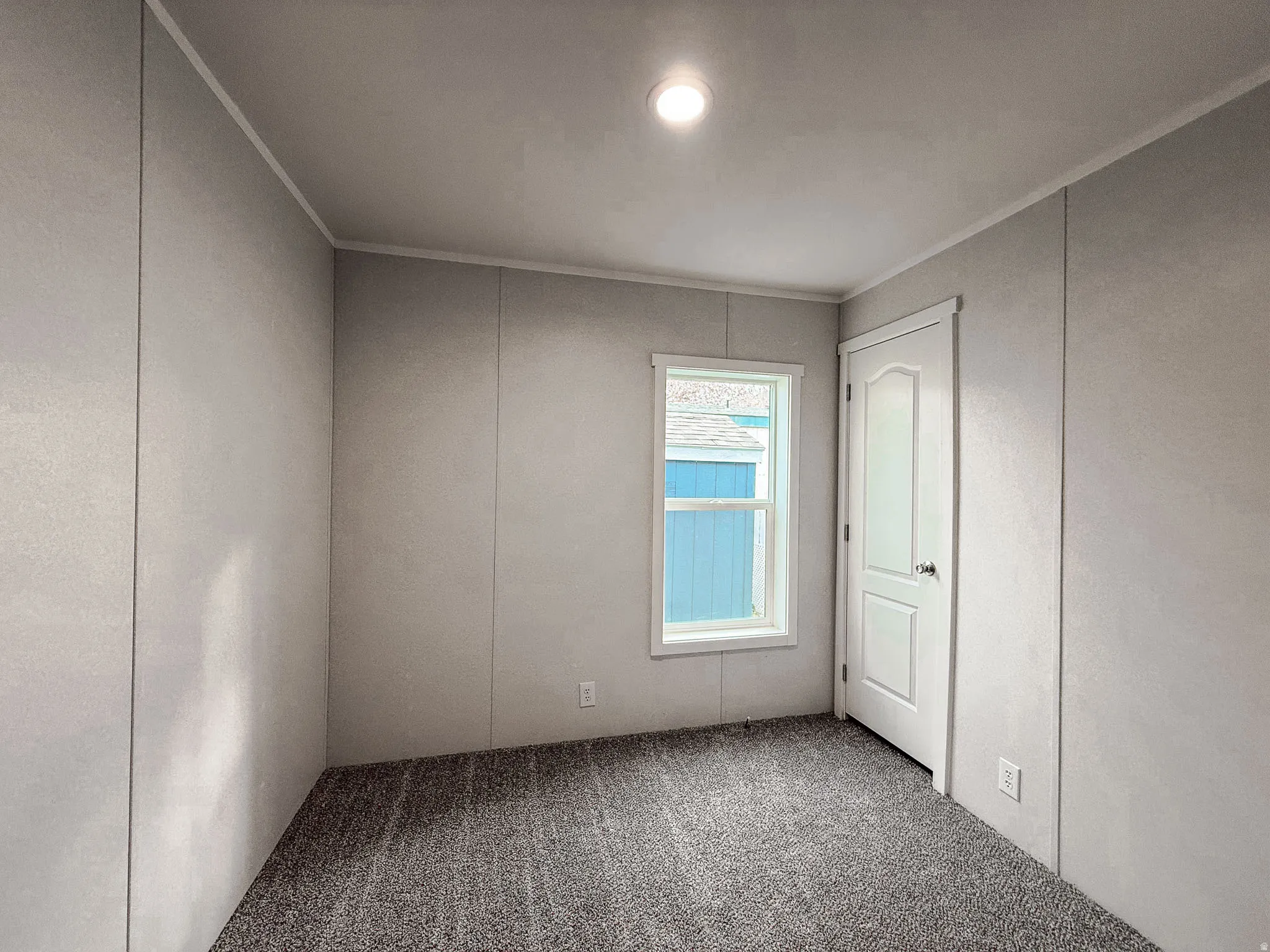 Unfurnished bedroom featuring carpet and crown molding