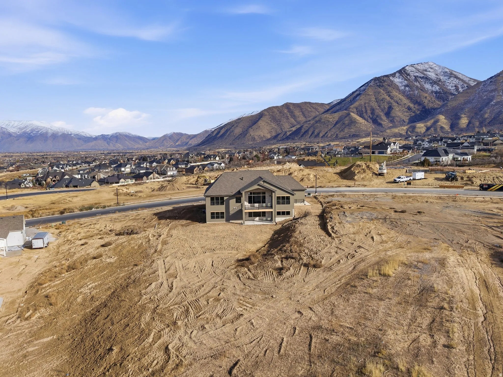 View of mountain backdrop featuring nearby suburban area