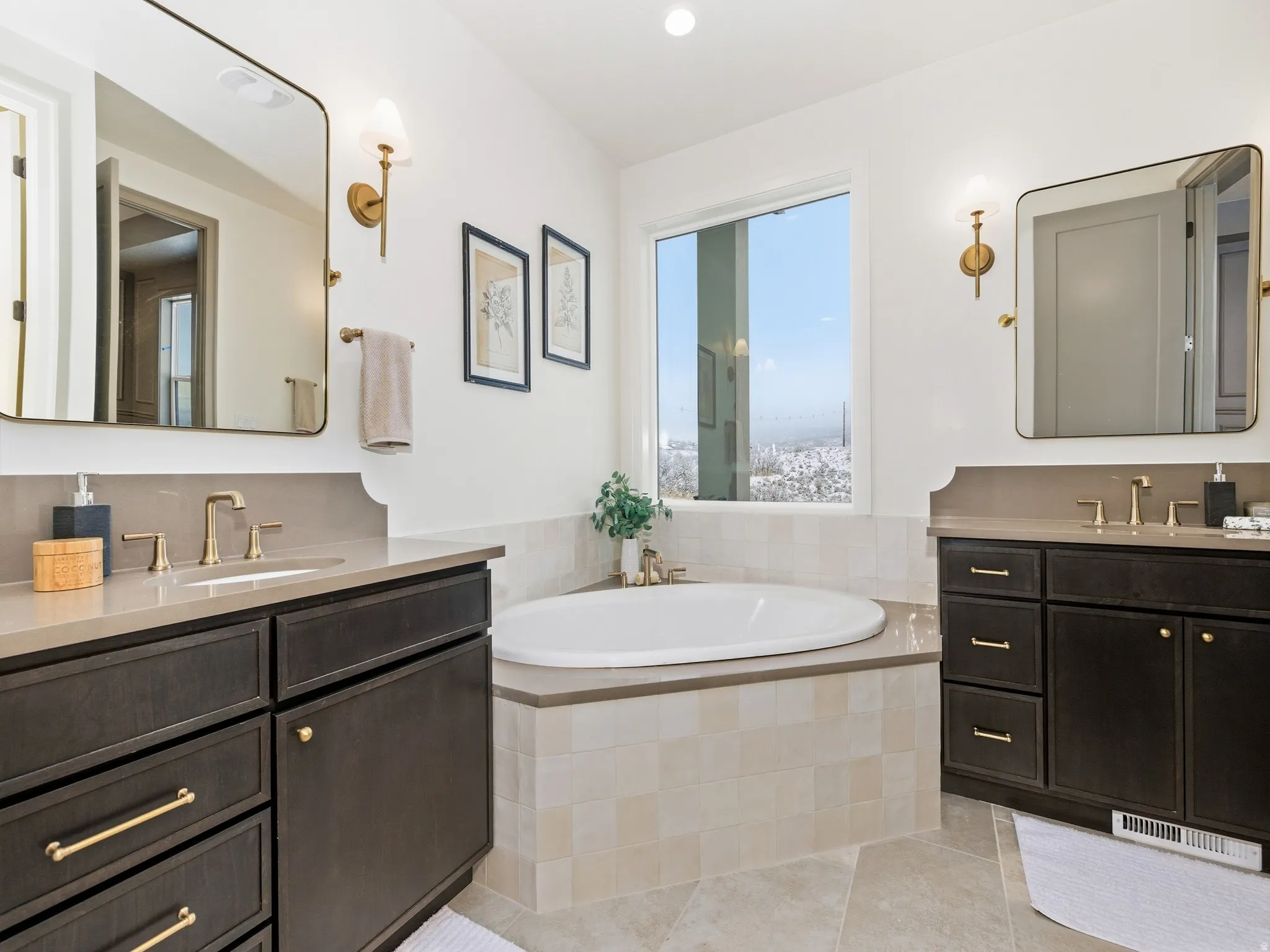 Bathroom featuring light tile patterned flooring, a garden tub, two vanities, and recessed lighting