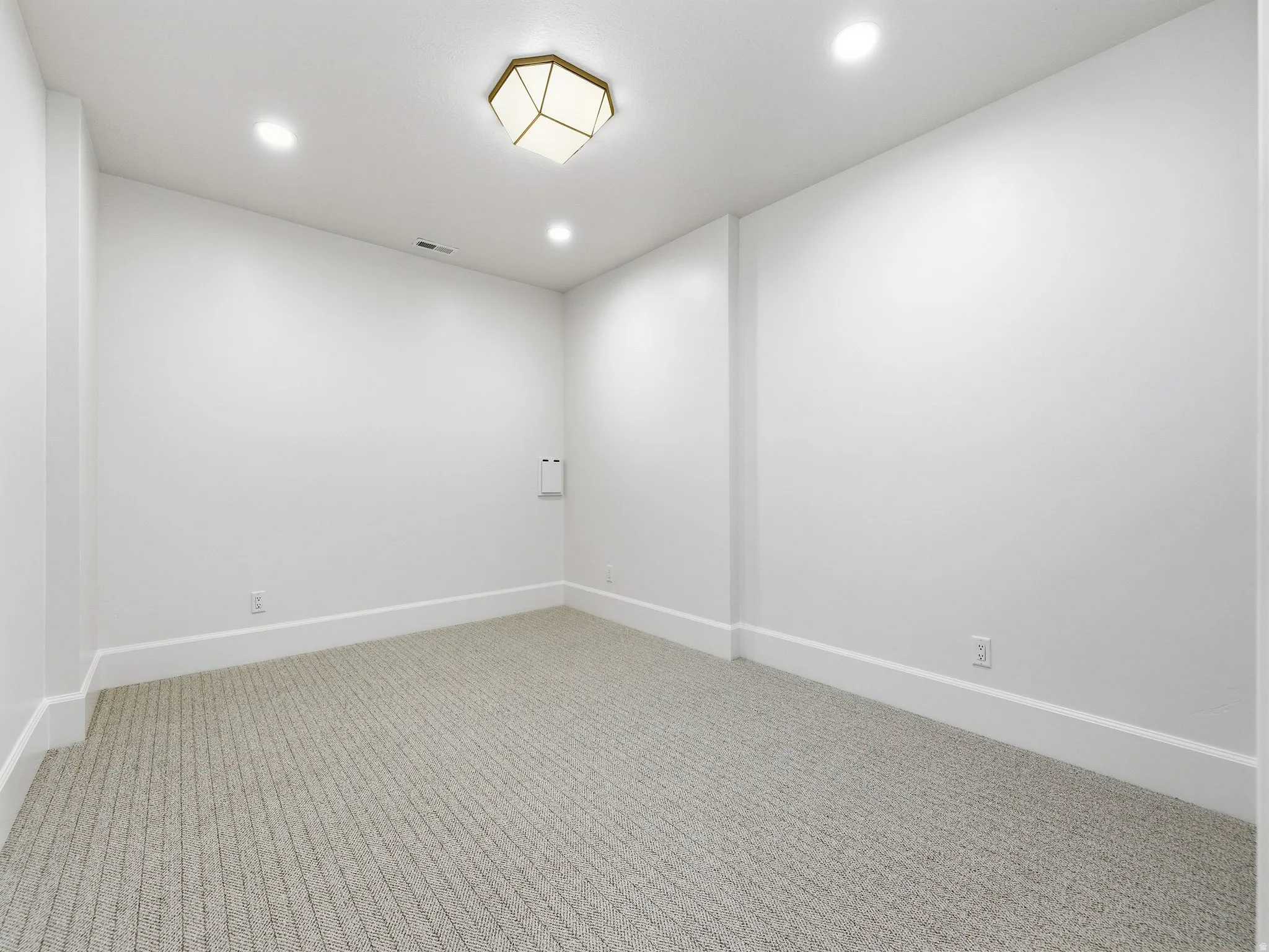 Spare room with carpet floors and recessed lighting