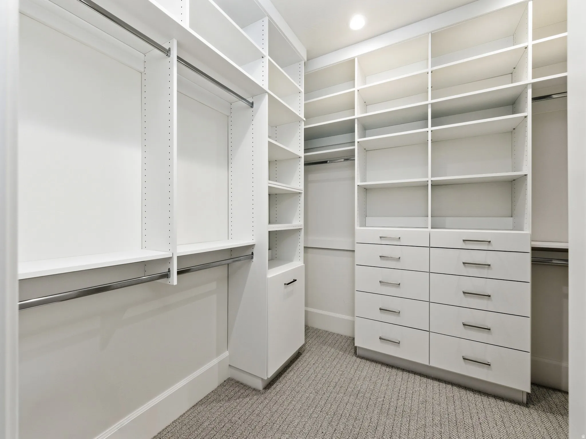 Walk in closet with light colored carpet