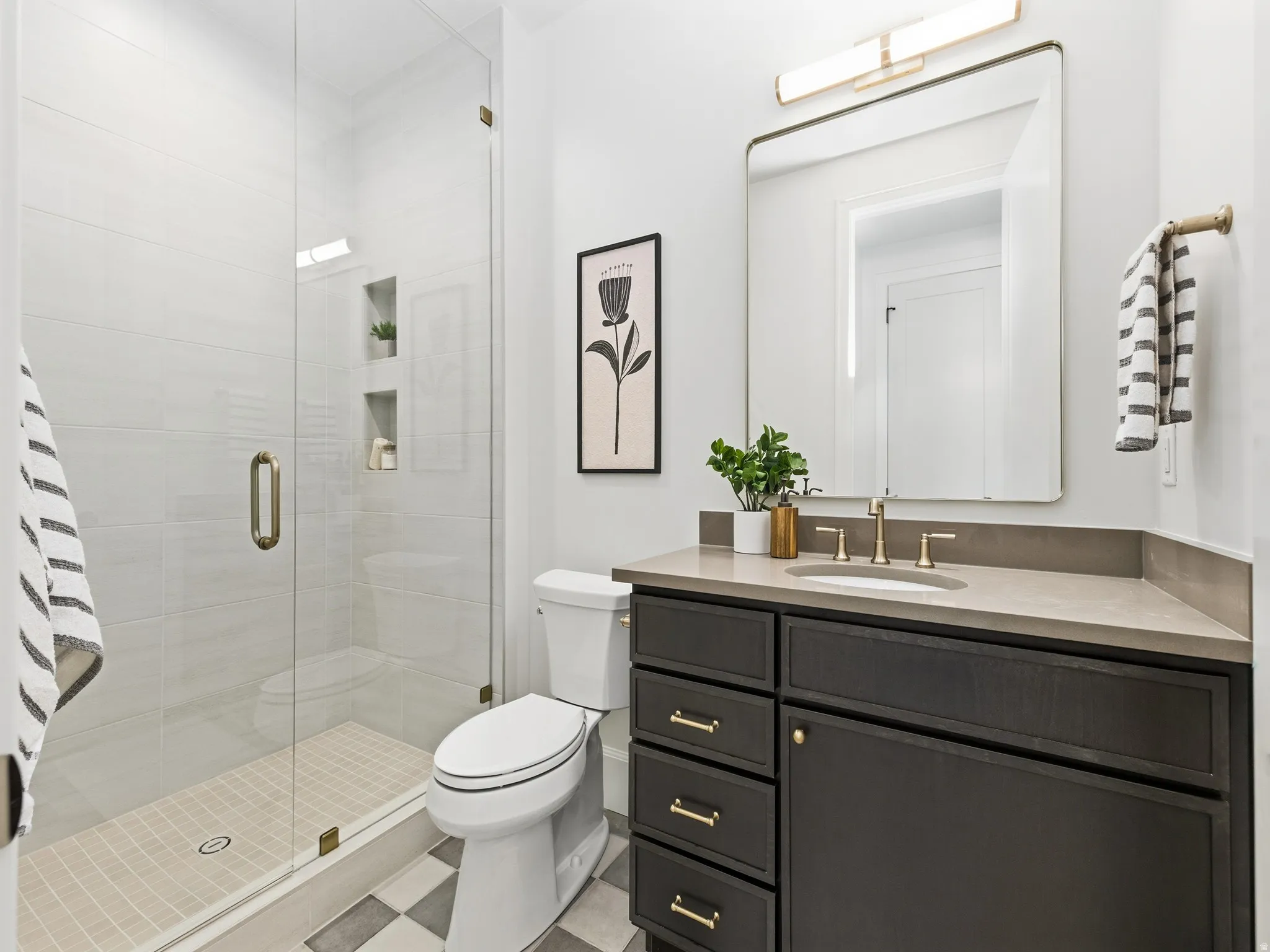 Full bath with a shower stall and vanity