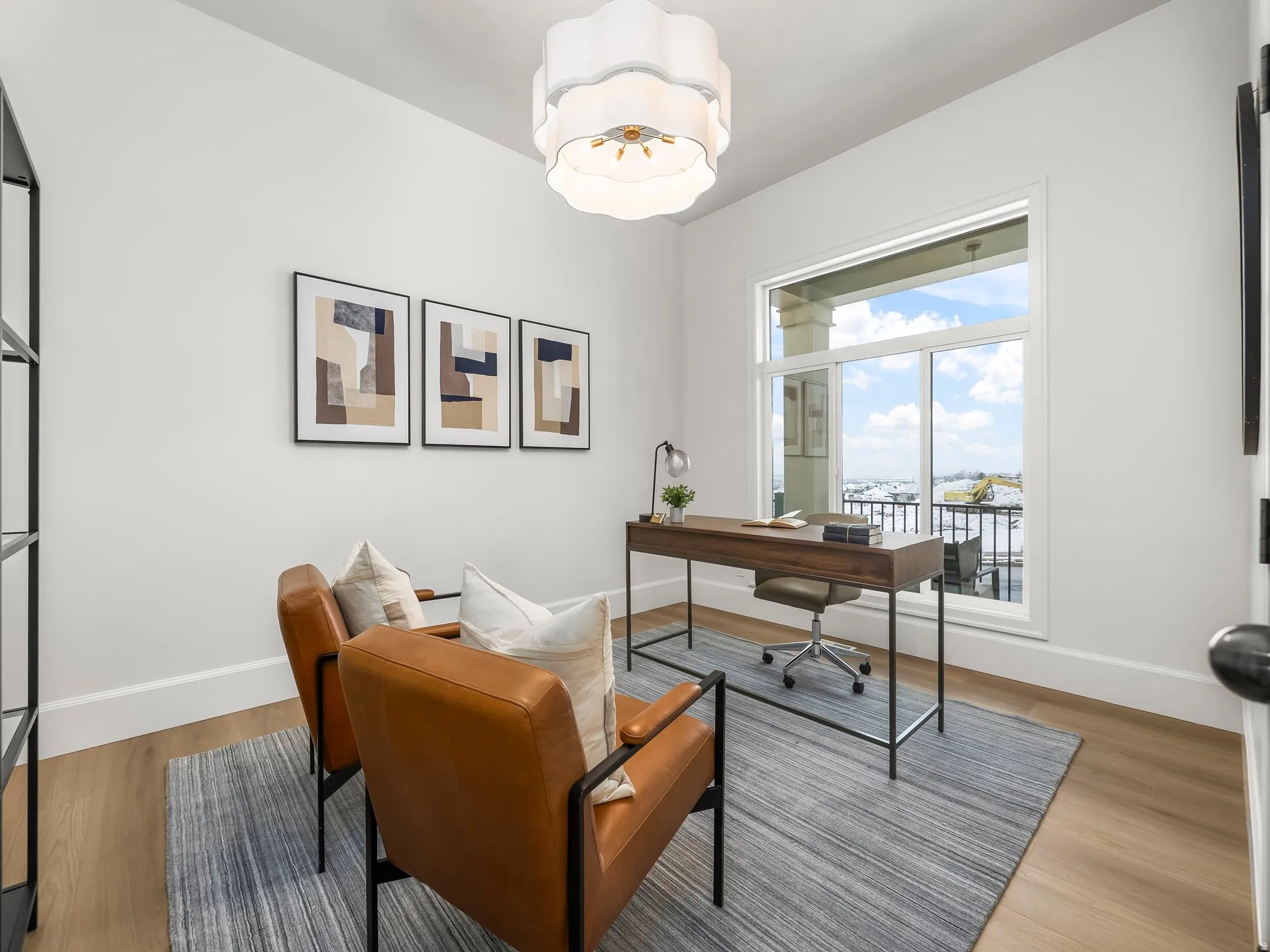 Home office with light wood-style floors and baseboards