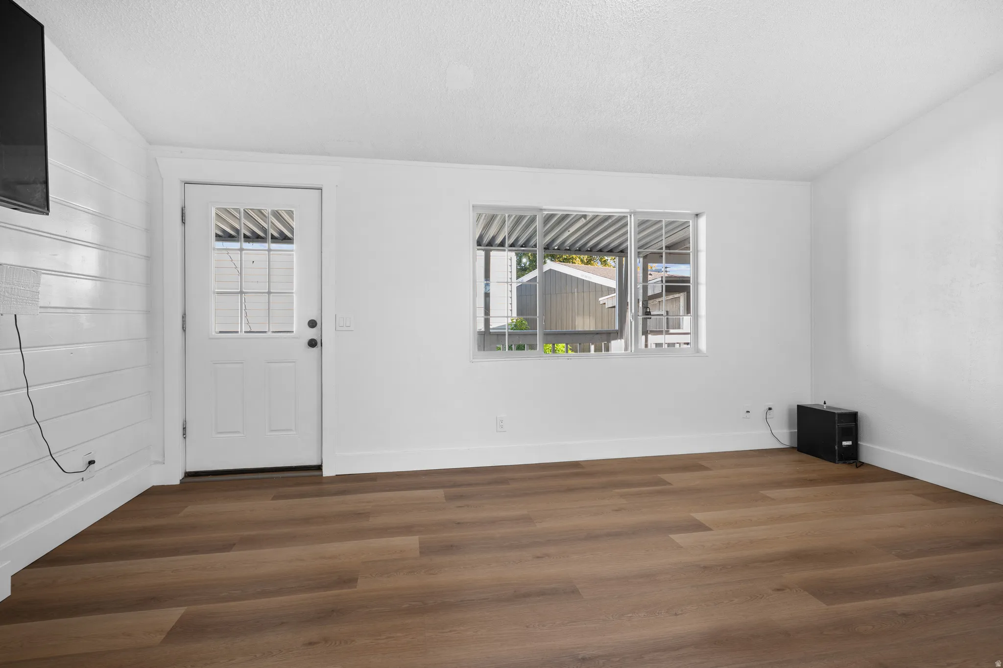 Entryway featuring dark wood finished floors and a textured ceiling