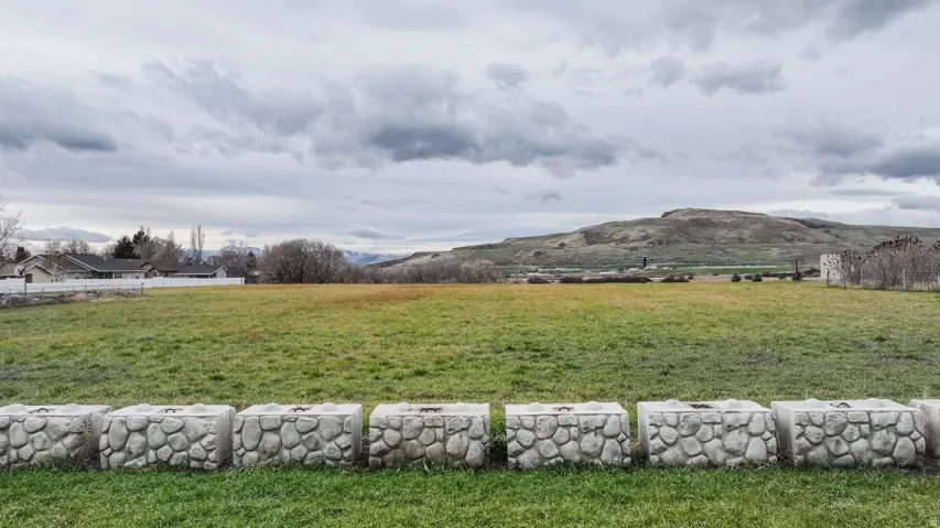 View of mountain backdrop with rural landscape