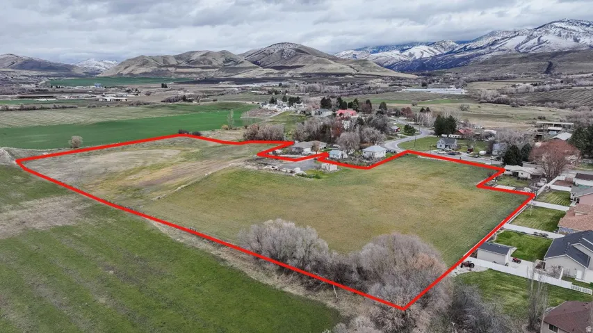 Aerial view of sparsely populated area featuring mountains and property boundaries highlighted