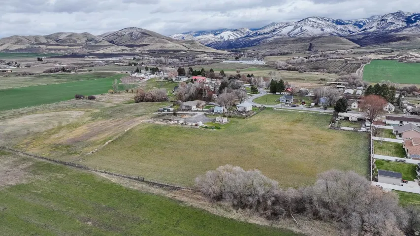 Aerial overview of property's location with a mountainous background and rural landscape