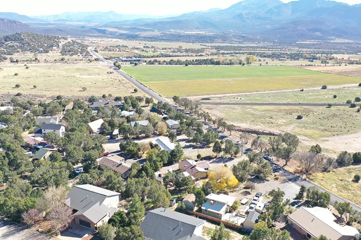 Aerial overview of property's location with mountains, nearby suburban area, and rural landscape
