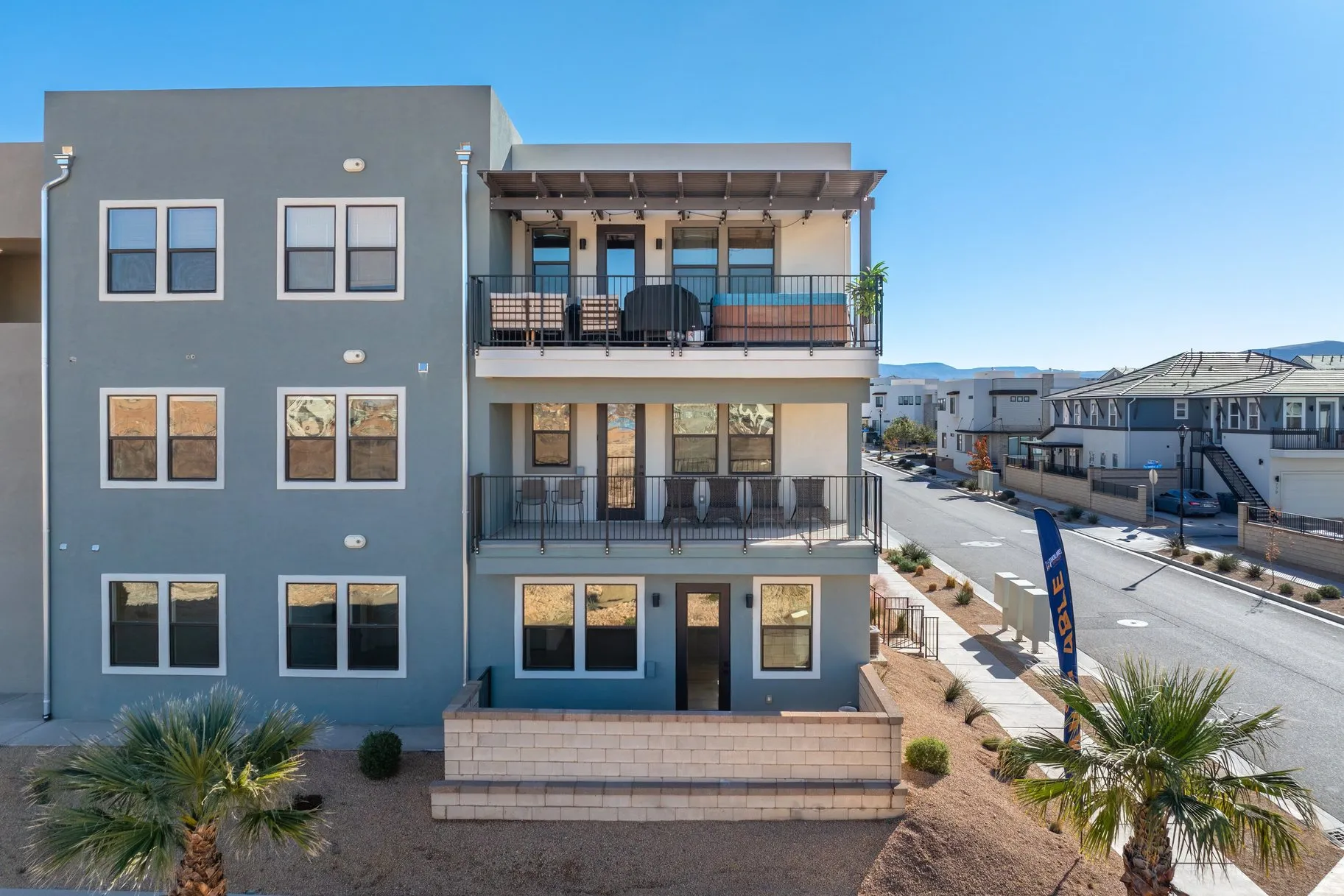 Back of property featuring stucco siding, a balcony, and a residential view