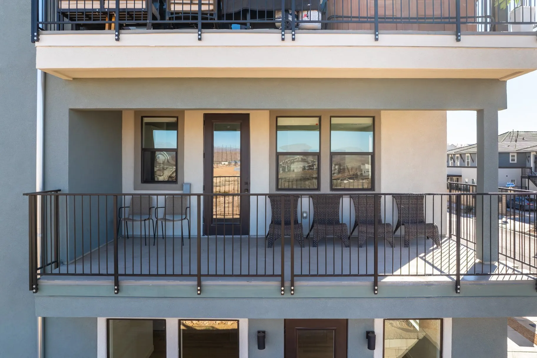 Back of property featuring a balcony and stucco siding