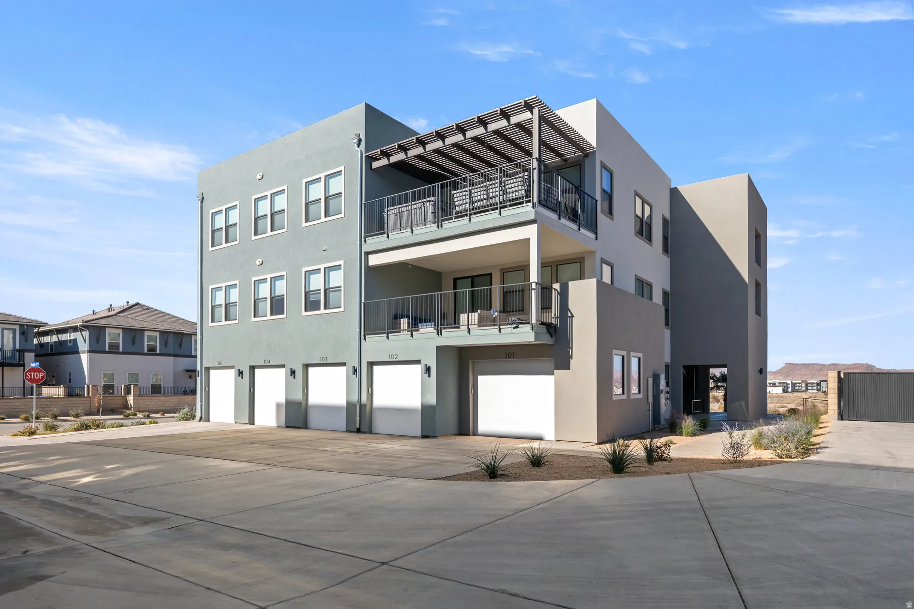 View of apartment building / complex with a garage and driveway