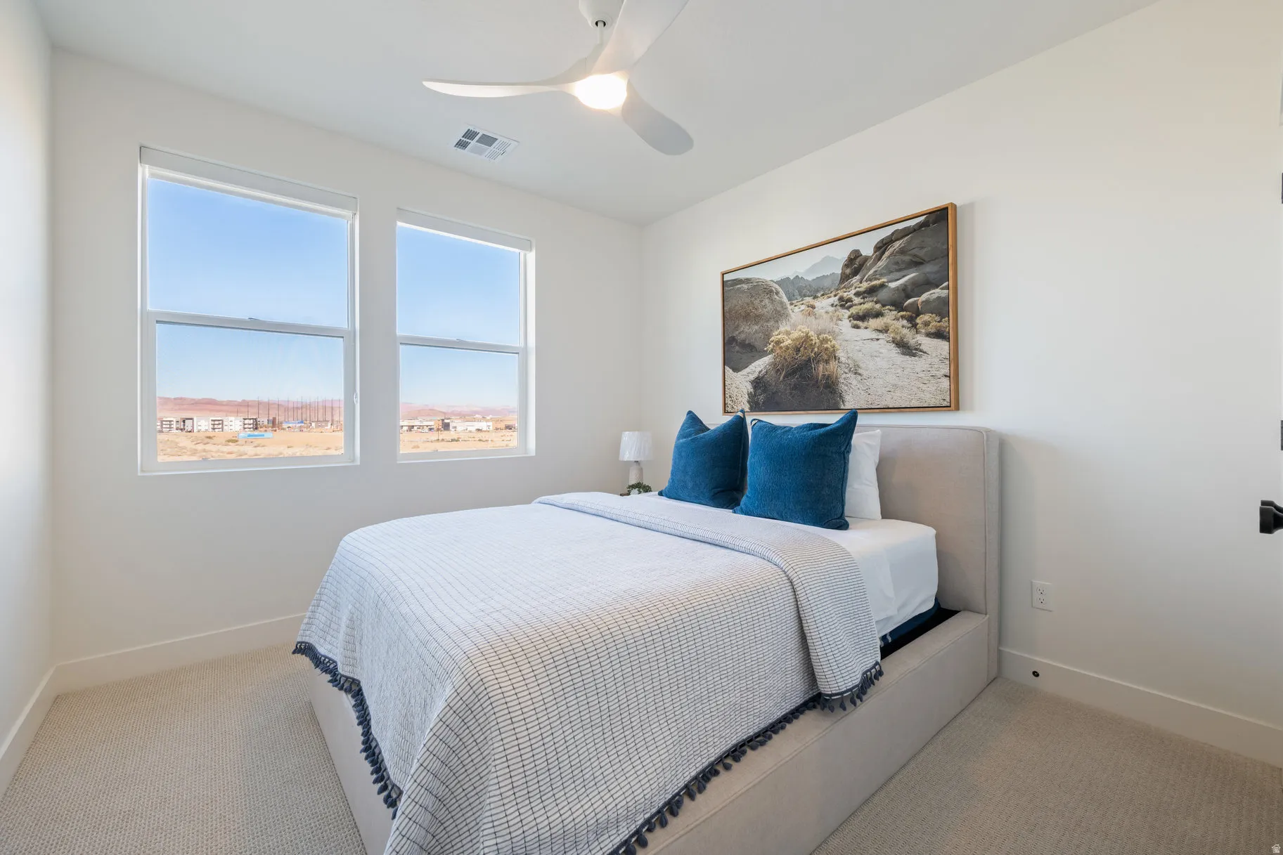 Bedroom featuring ceiling fan and light carpet