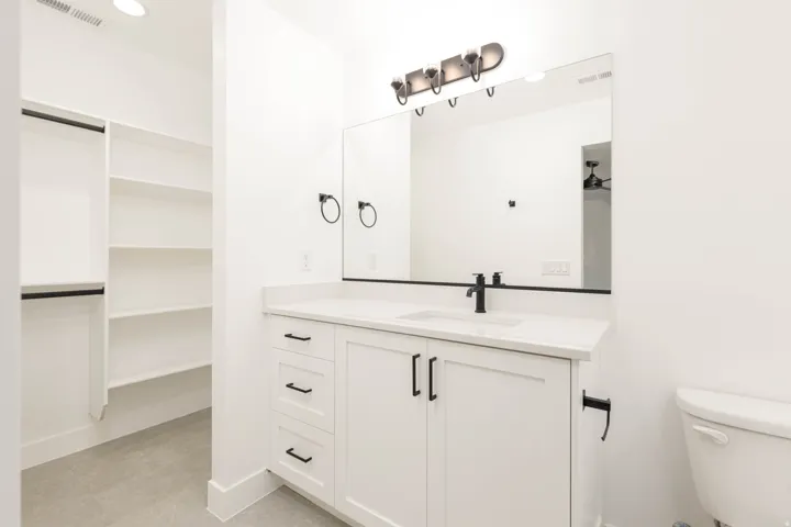 Bathroom with vanity and recessed lighting