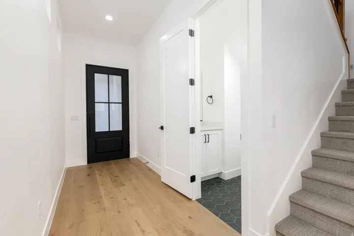 Entrance foyer with stairway, light wood-style flooring, and recessed lighting