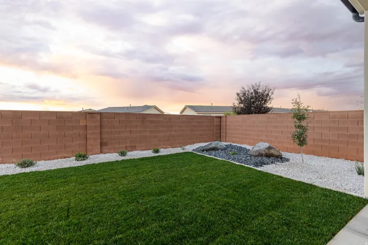 Yard at dusk featuring a fenced backyard