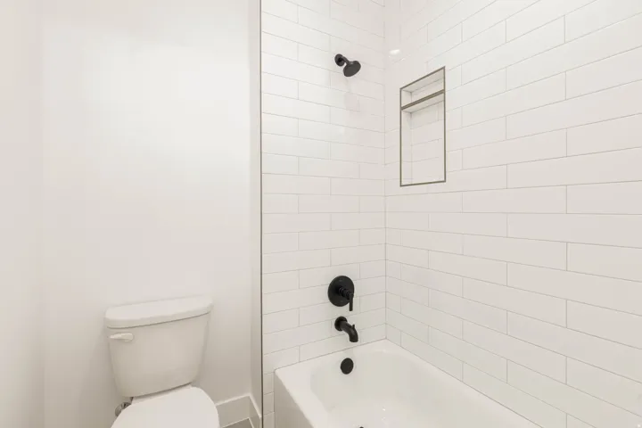 Bathroom featuring bathing tub / shower combination and toilet