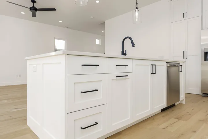 Kitchen featuring white cabinets, light wood-style floors, stainless steel appliances, and recessed lighting