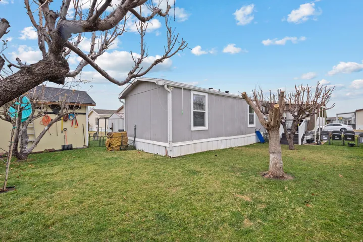 View of property exterior with a lawn