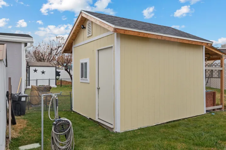 View of shed featuring a fenced backyard
