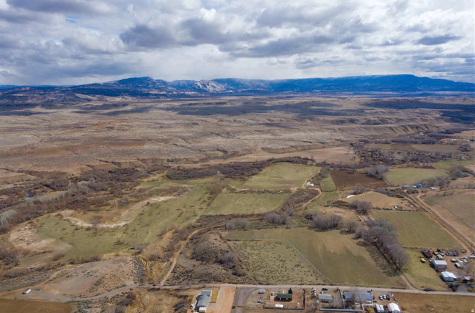 Aerial view of property and surrounding area with mountains and rural landscape