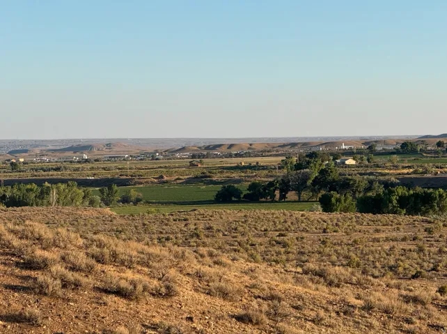 View of mountain backdrop featuring rural landscape