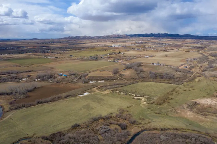 Aerial overview of property's location featuring rural landscape and a mountainous background