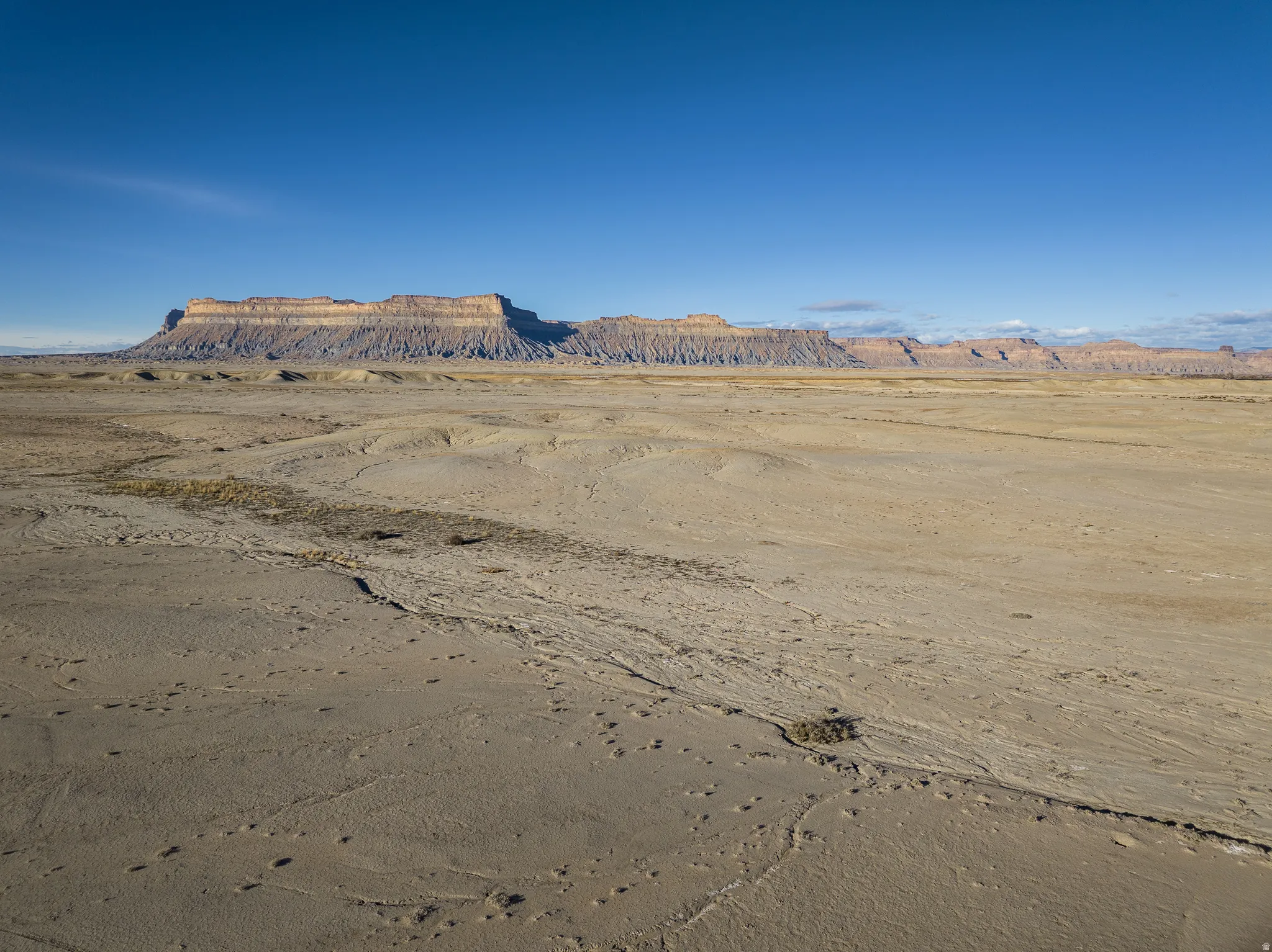View of mountain backdrop with a desert landscape and rural landscape