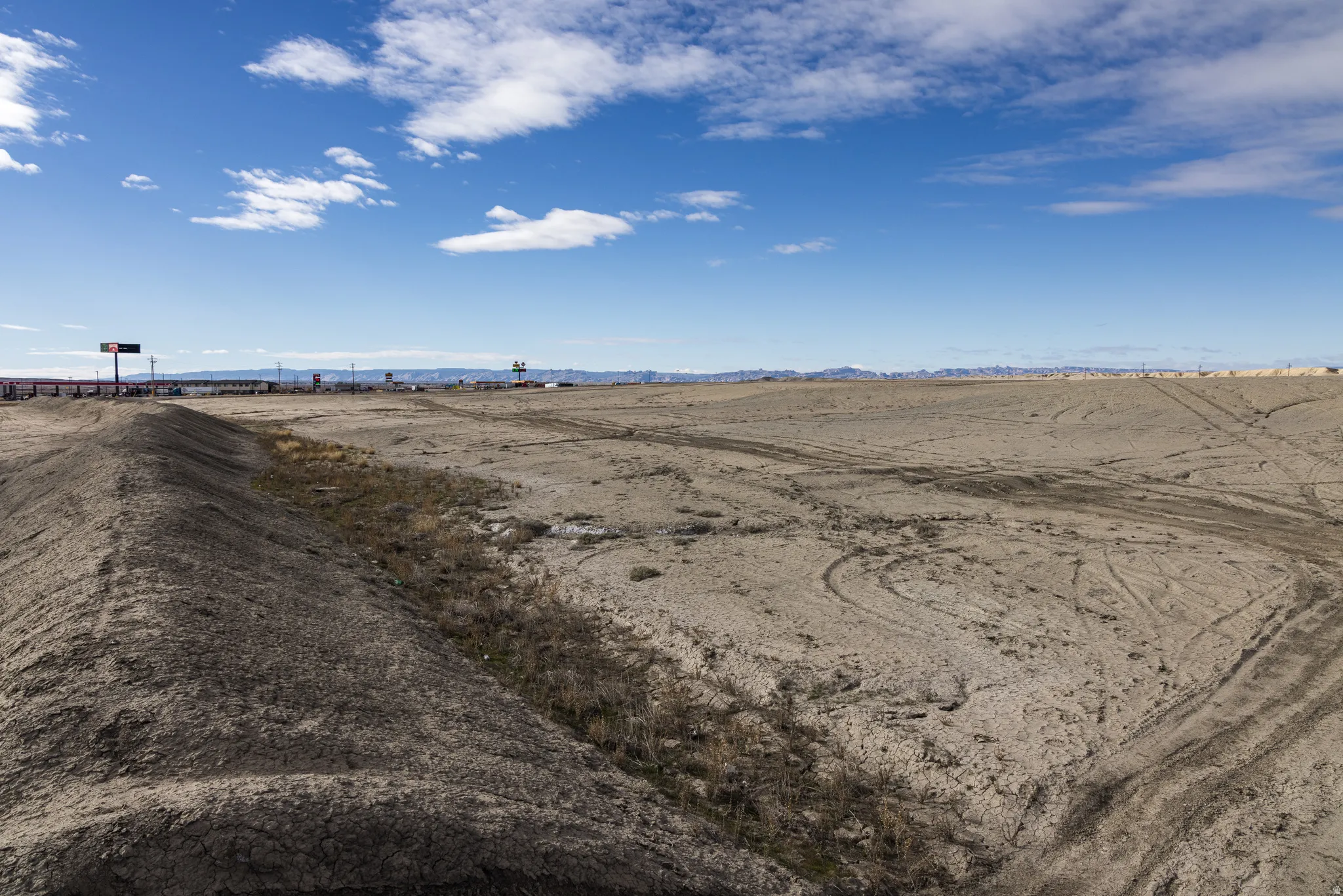 View of dirt / gravel road featuring a view of rural / pastoral area