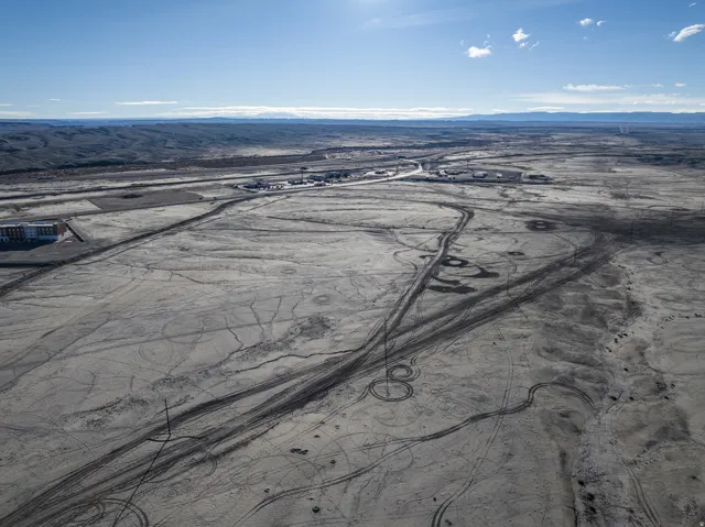 Aerial view of sparsely populated area with a mountainous background