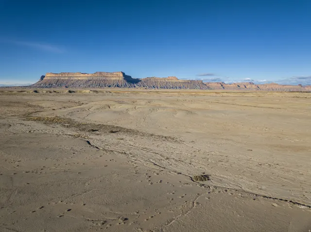 View of mountain backdrop with a desert landscape and rural landscape