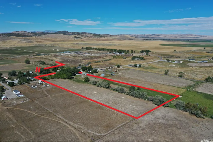 View of rural area with property boundaries highlighted and a mountainous background