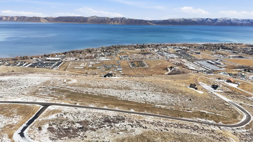 Aerial view of property's location featuring a water and mountain view