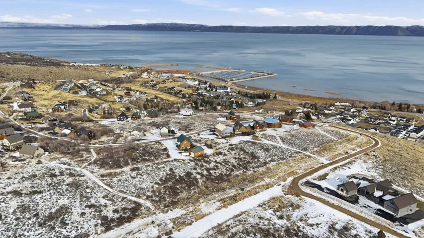 Aerial view of property's location with nearby suburban area and a water and mountain view