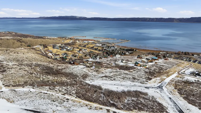 Aerial view of property's location with a water and mountain view