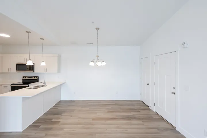 Open-concept living space with wood-finish flooring