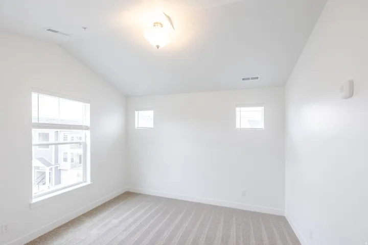 Vaulted ceiling featuring a flush-mount light fixture