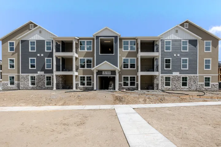View of front facade with stone siding and board and batten siding
