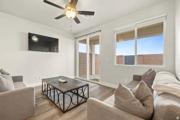 Living room with wood finished floors and a ceiling fan