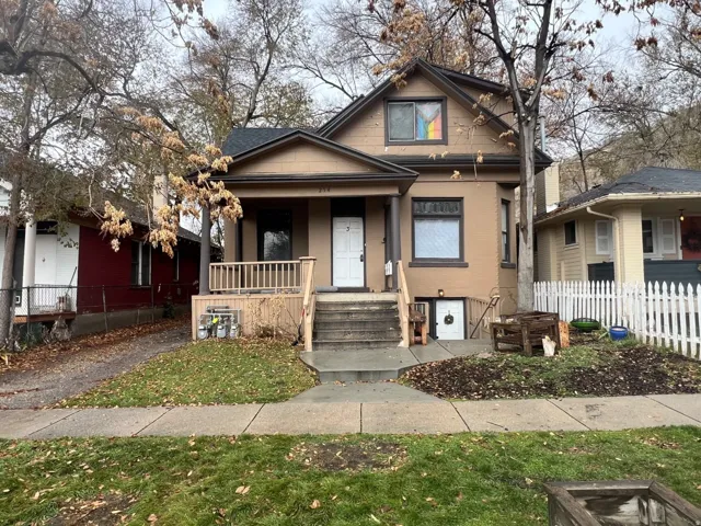 Bungalow-style house featuring a porch and brick siding