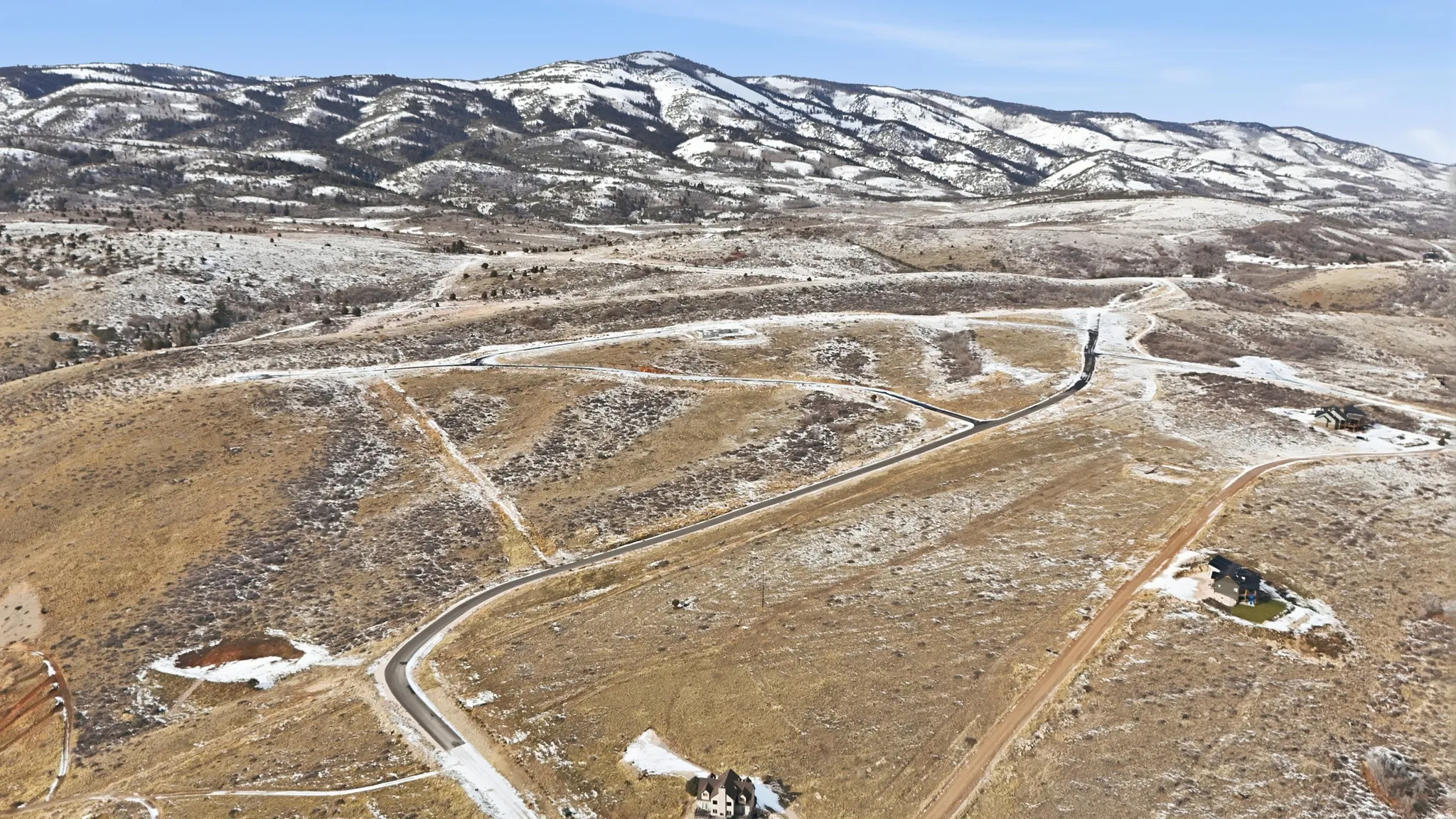 View of mountain backdrop with rural landscape