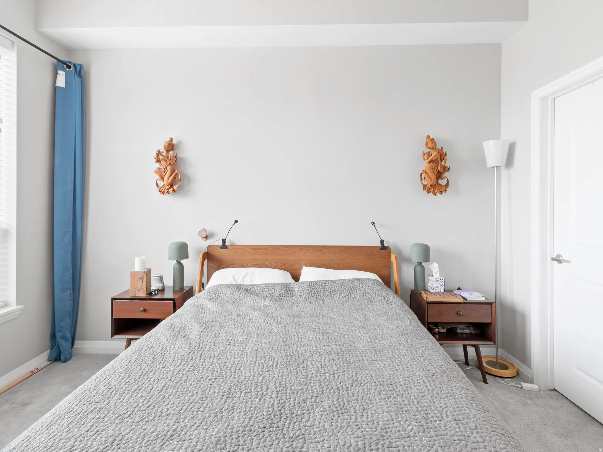 Bedroom featuring light carpet and baseboards