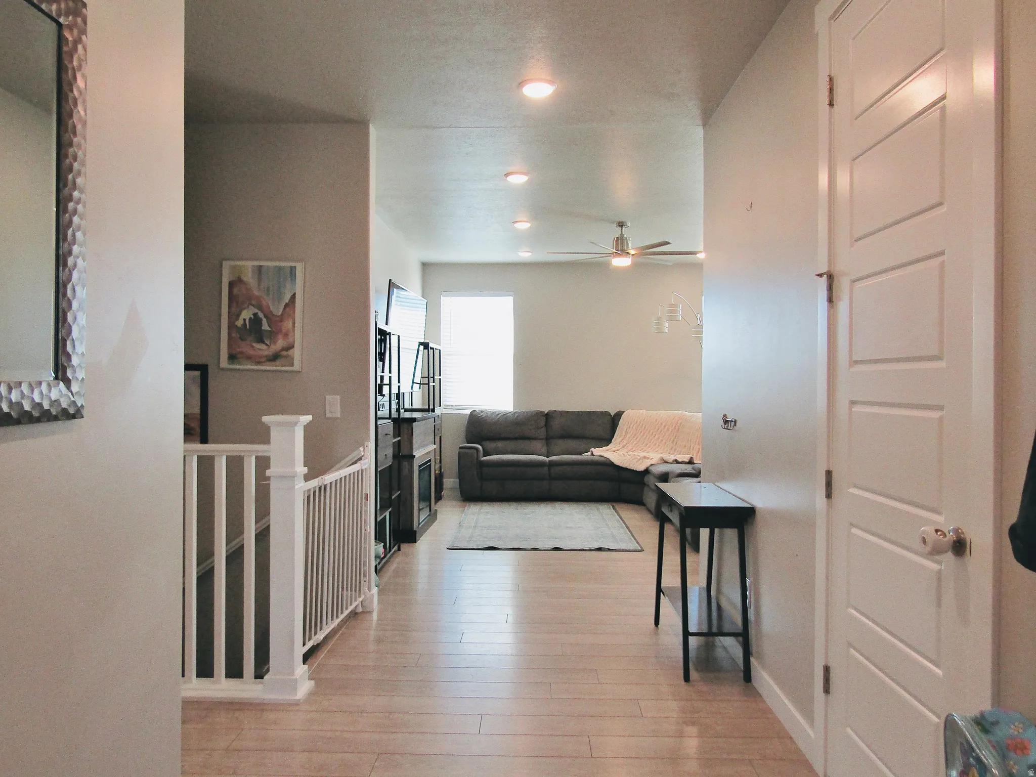 Hall featuring light wood-type flooring and an upstairs landing