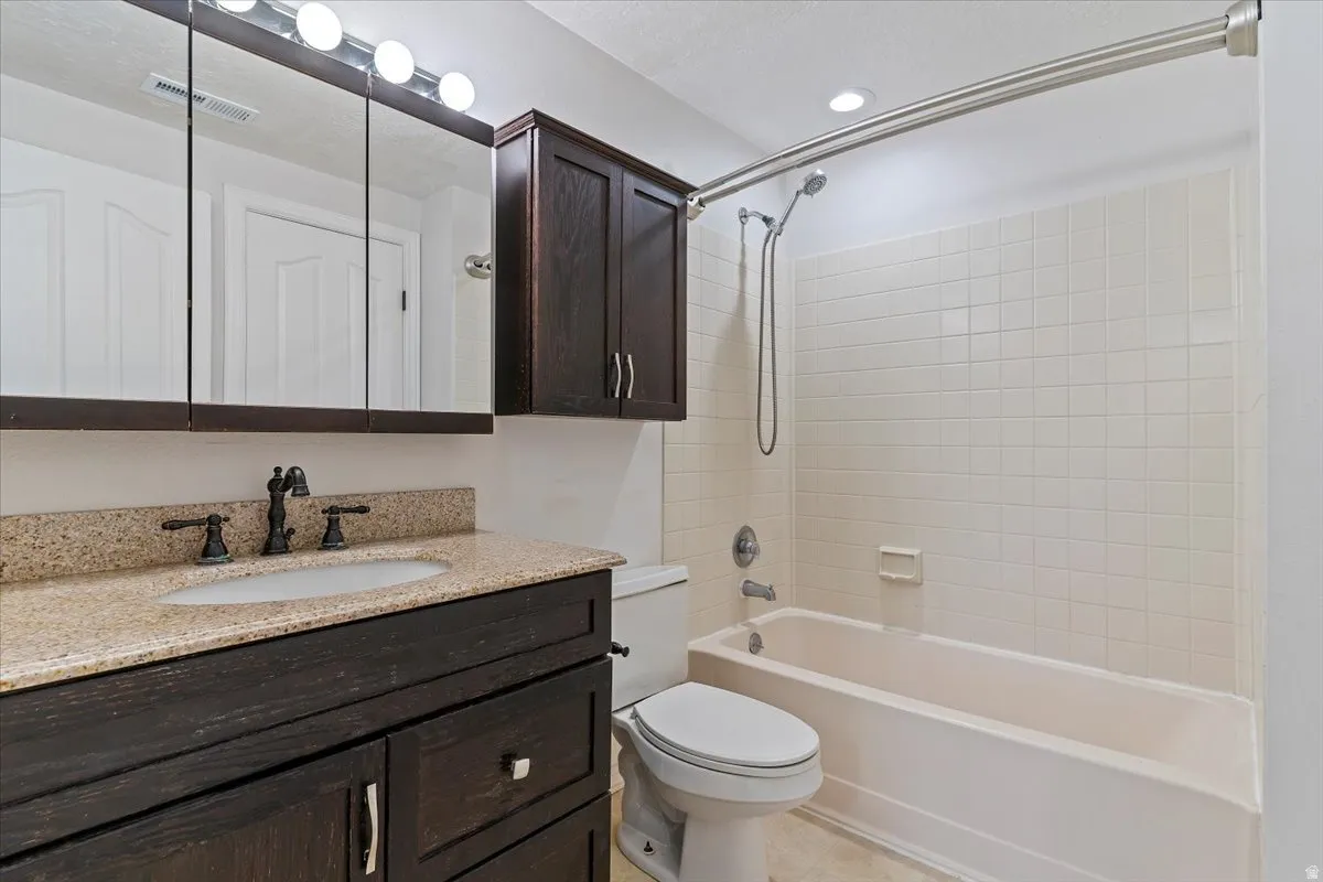 Full bath featuring vanity and shower / tub combination