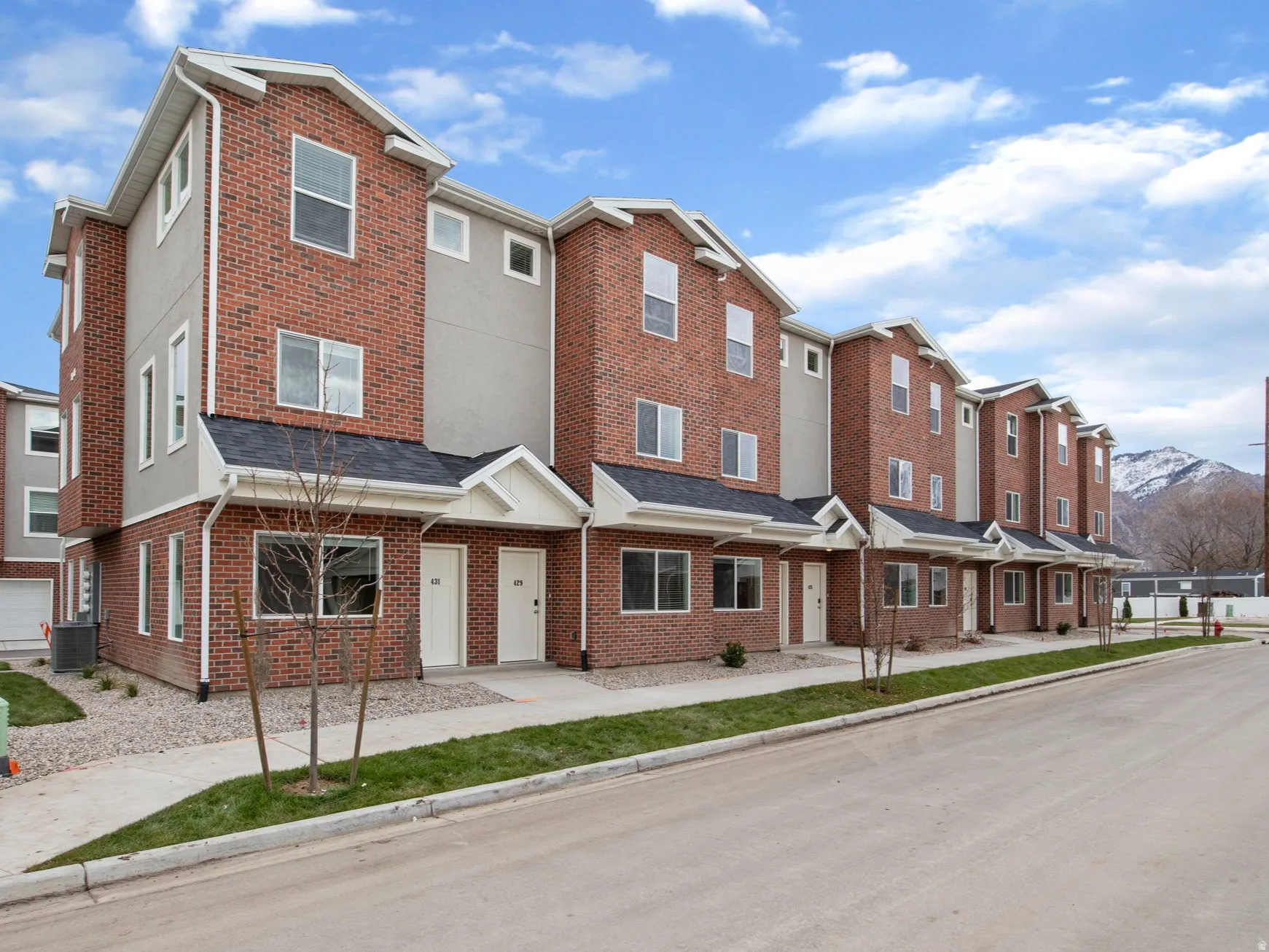 View of building exterior with a residential view and a mountain view