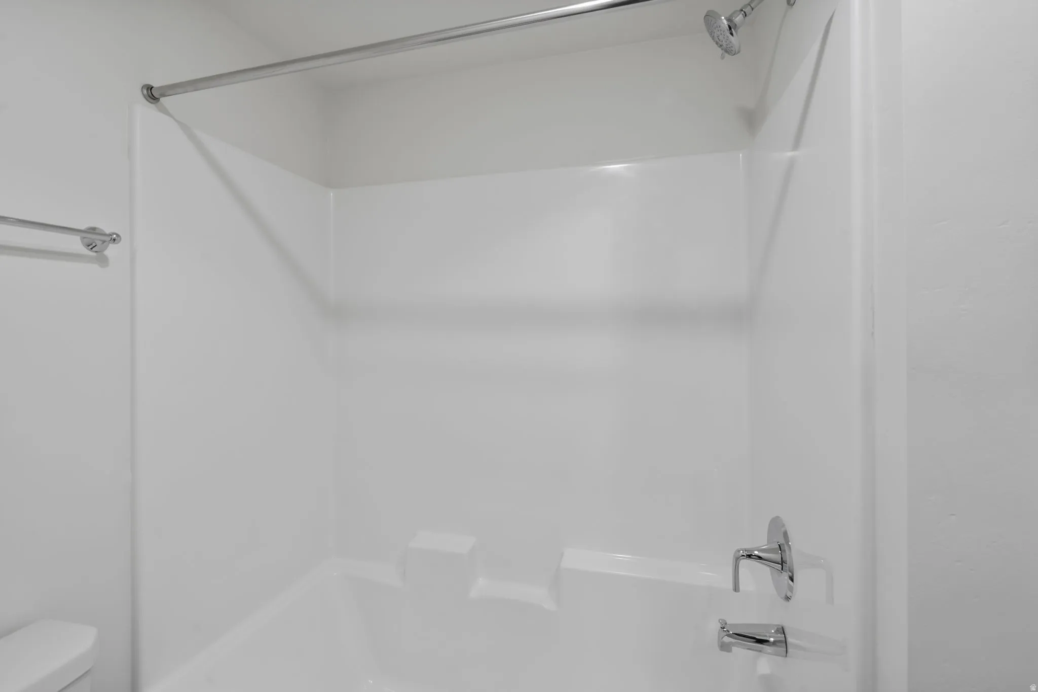 Bathroom featuring  shower combination and toilet