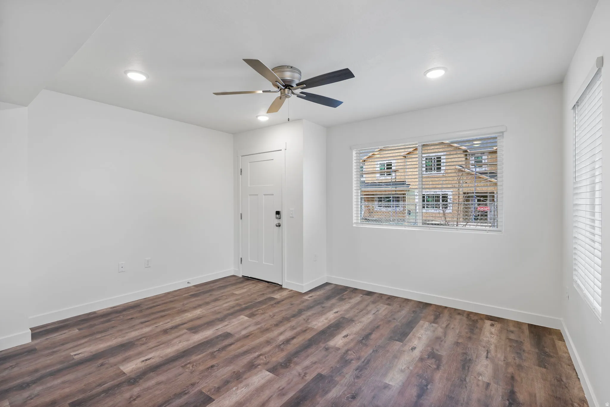 Entrance foyer featuring dark wood-style flooring, a ceiling fan, and recessed lighting