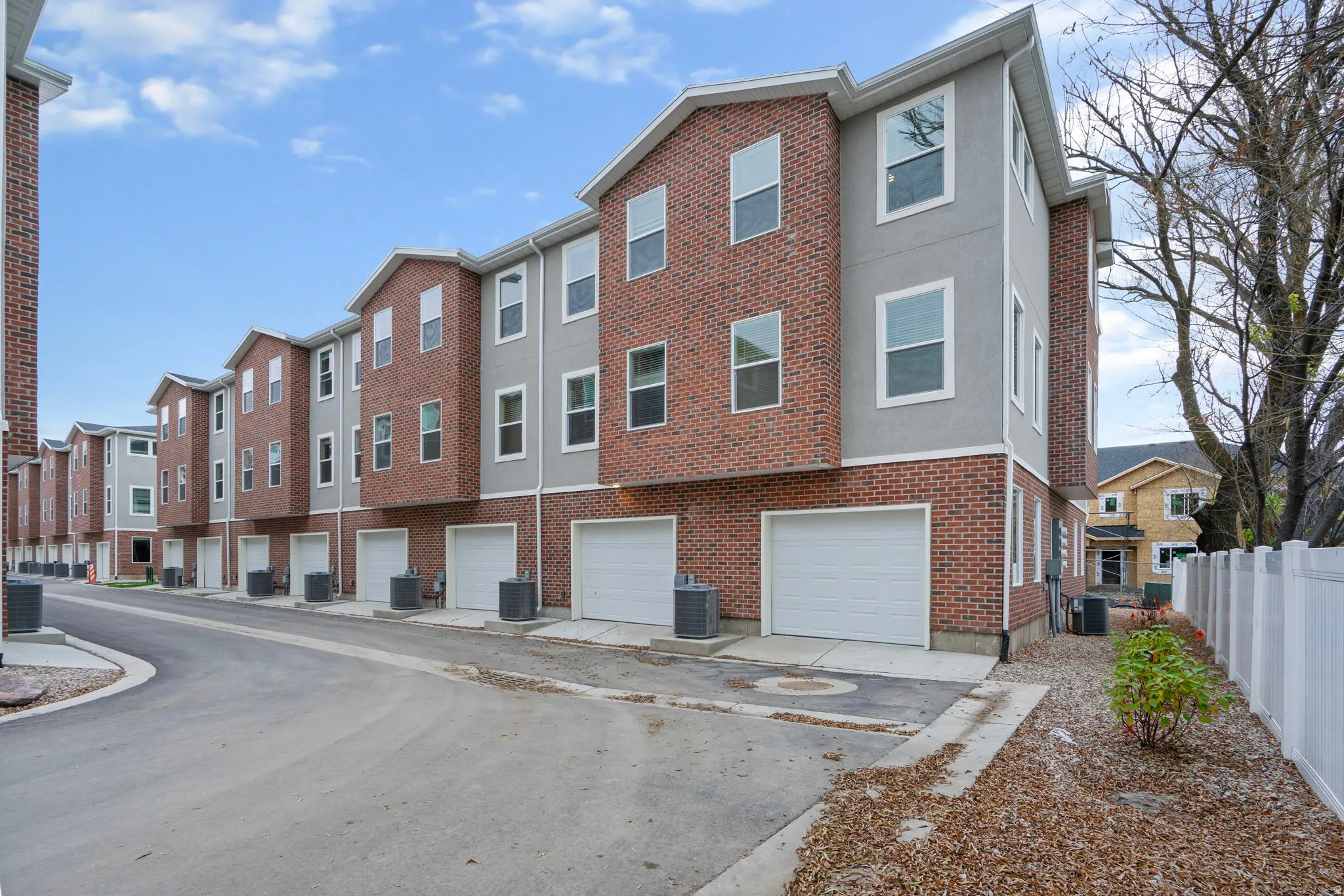 View of building exterior with an attached garage and driveway