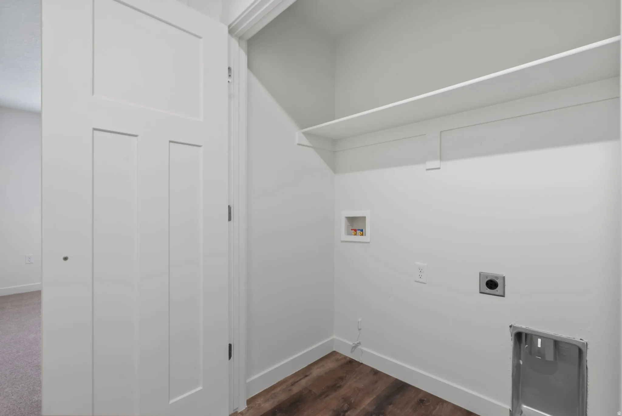 Washroom with hookup for a washing machine, hookup for an electric dryer, and dark wood-style floors
